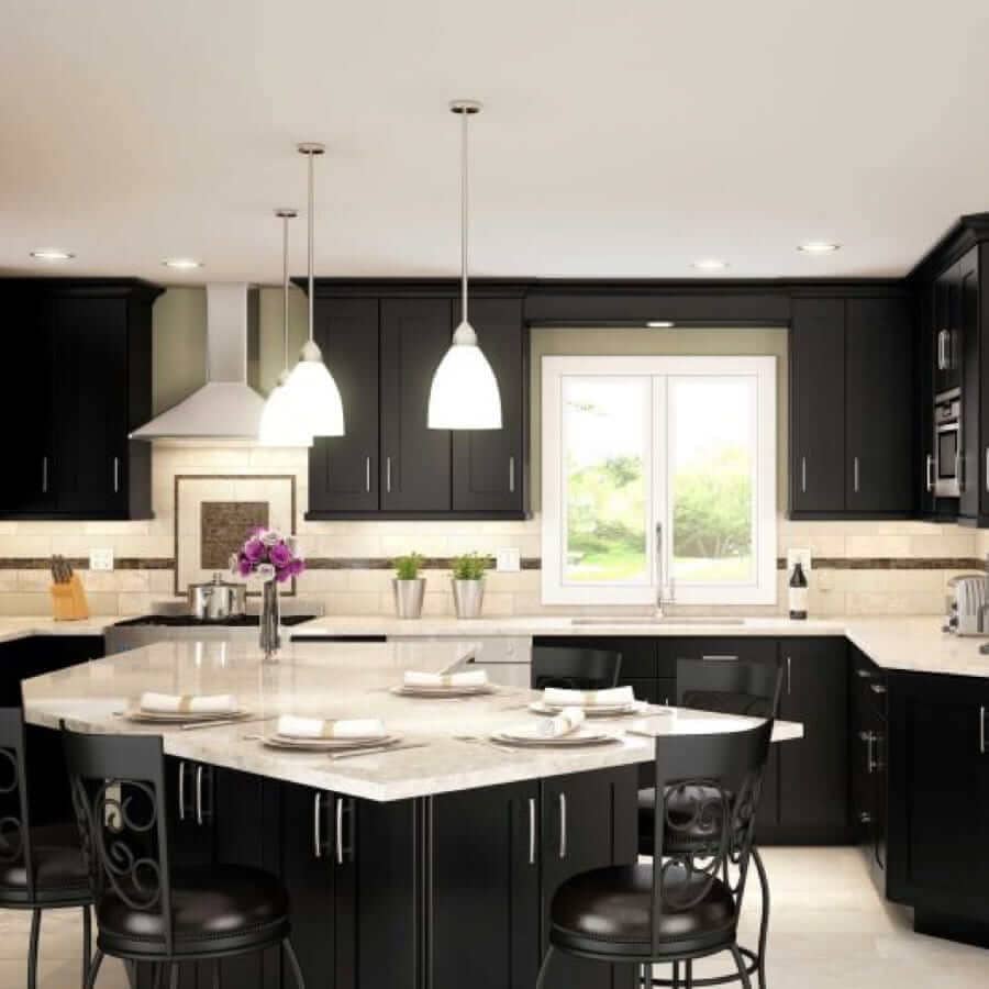 A kitchen with dark cabinets and light countertops
